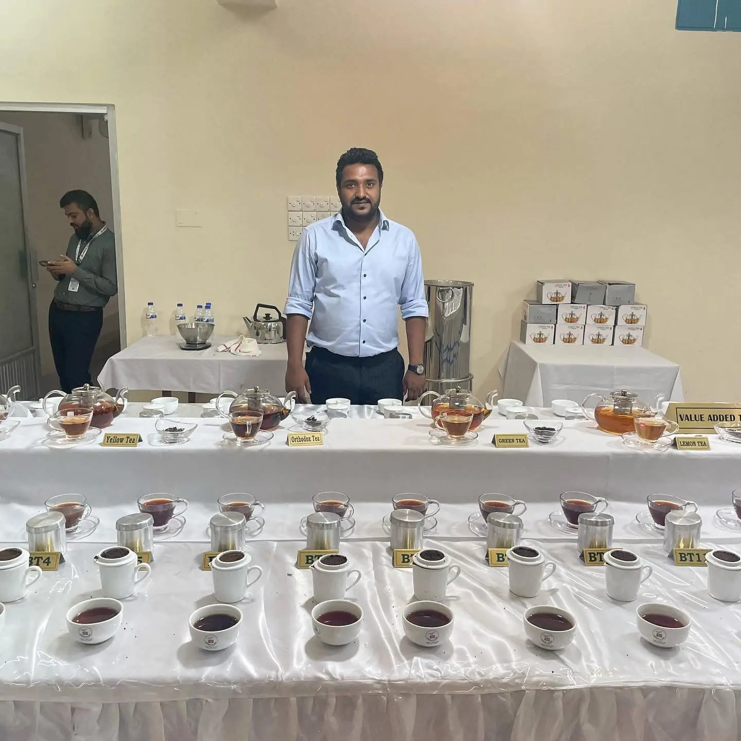 Cyrus beside a display of Faizi tea samples